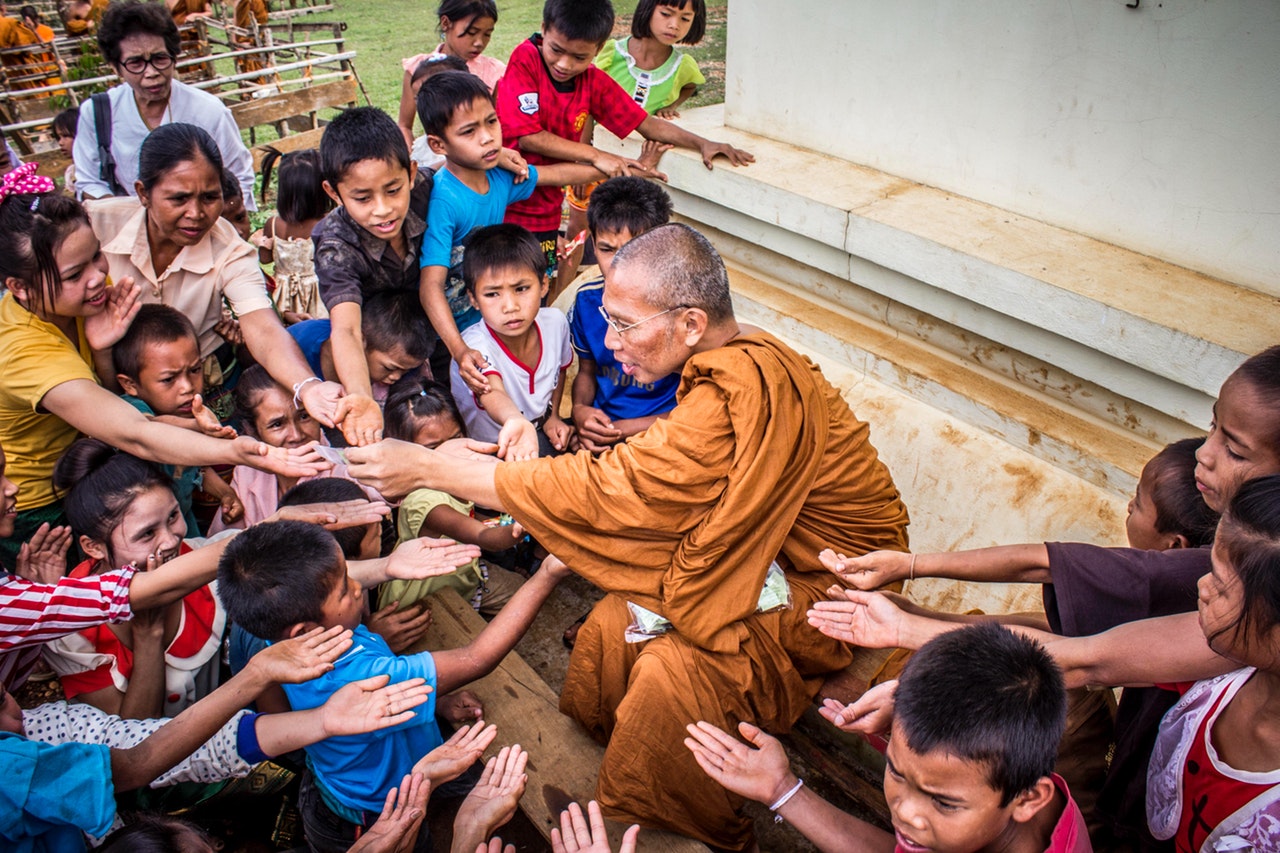 monk-surrounded-by-children-933624