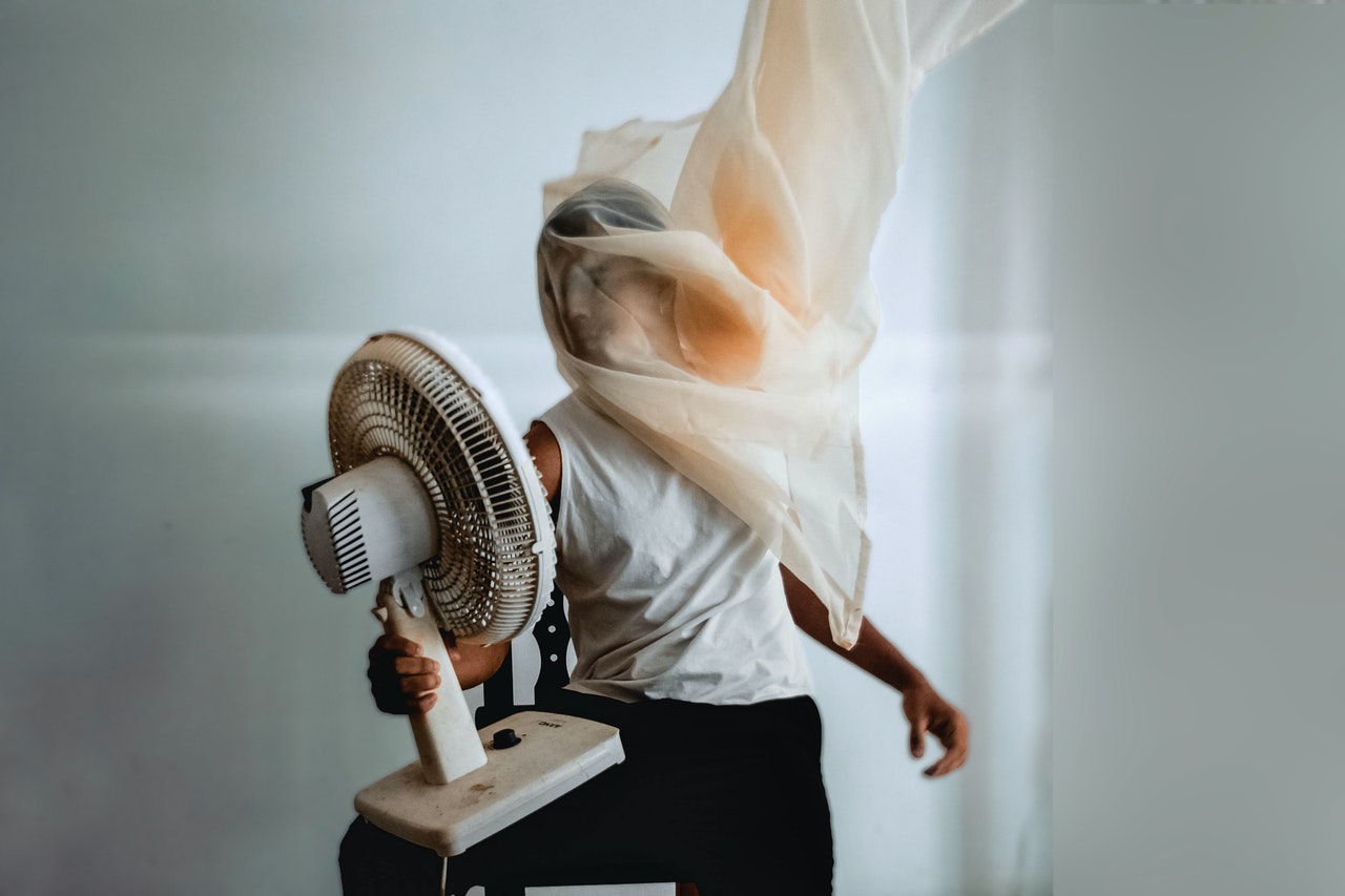 photo-of-person-holding-electric-fan