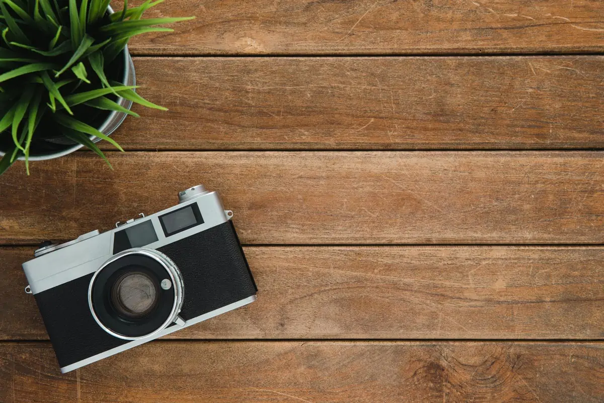 Black-and-Silver-Film-Camera-on-Brown-Wooden-Surface