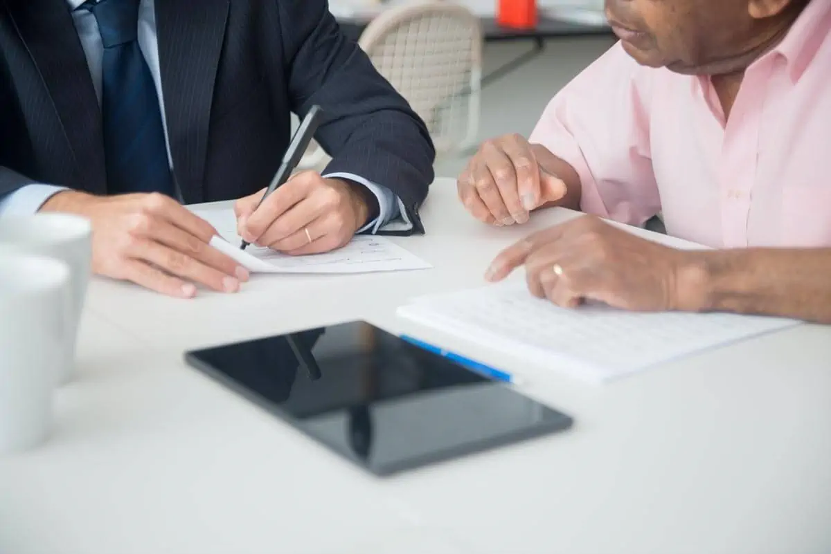 Man-in-Black-Suit-Jacket-Writing-on-White-Paper