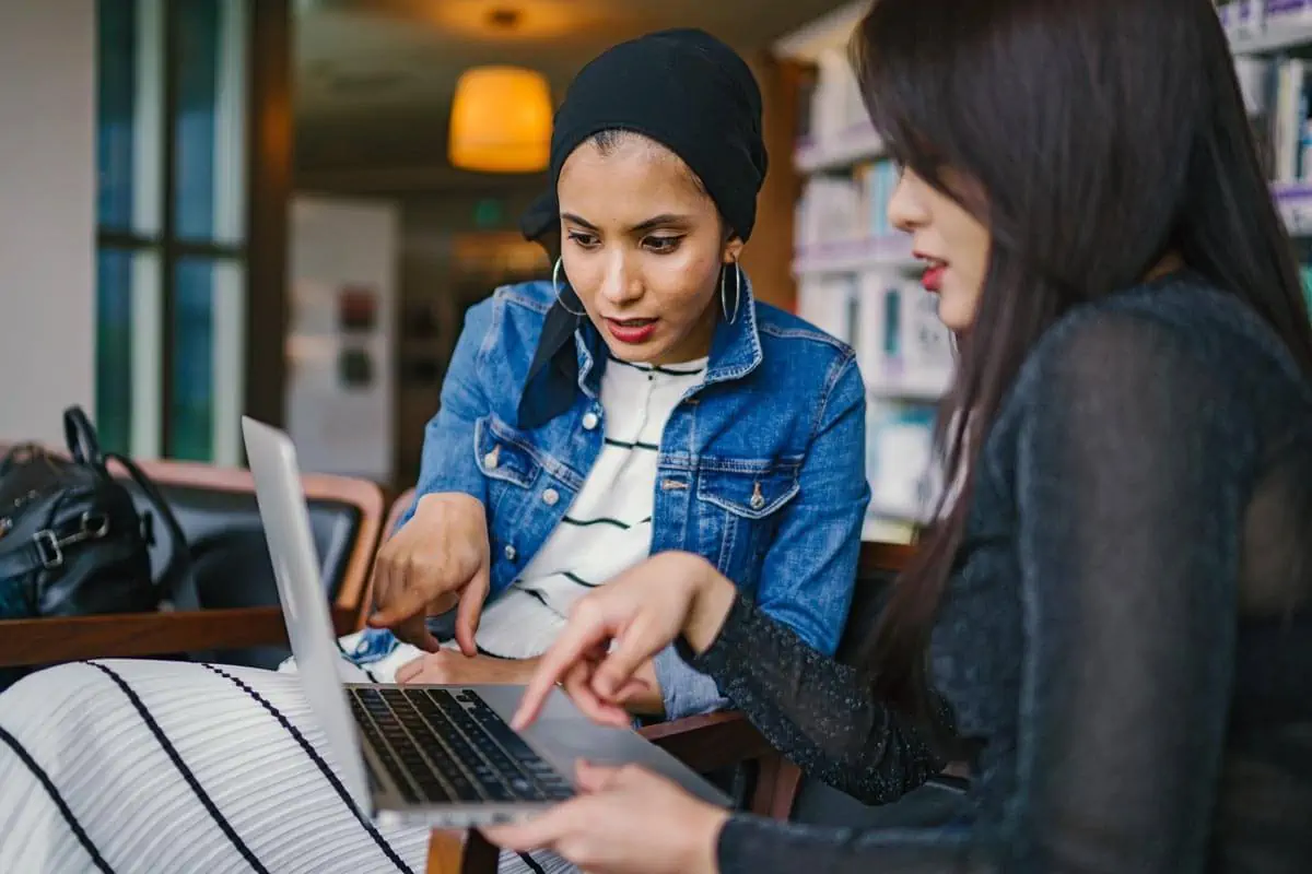 Two-Women-Looking-At-Macbook-Laptop