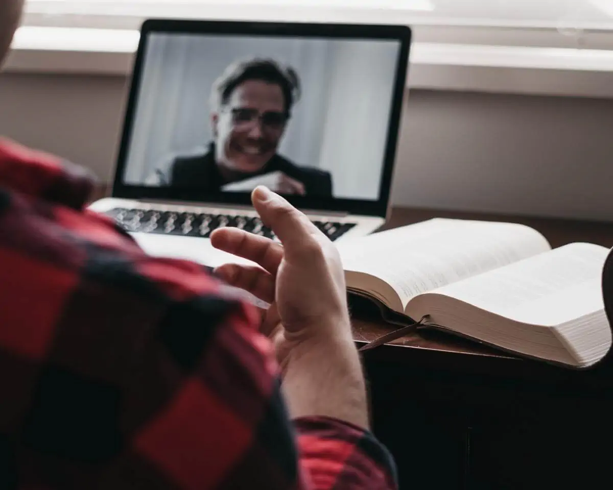 person-in-red-and-black--using-black-laptop-computer